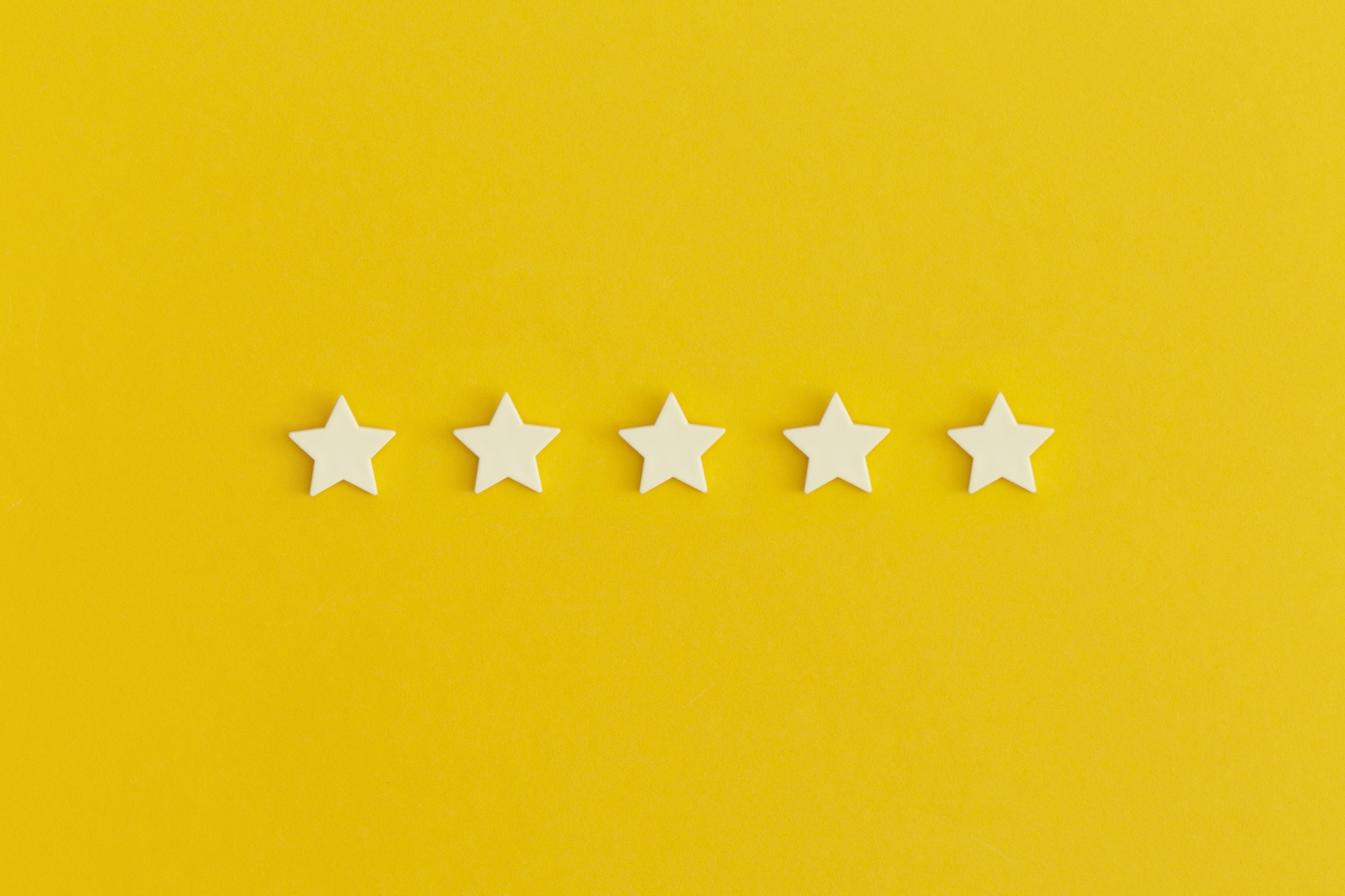 Five 5 stars, best excellent services rating on yellow background.